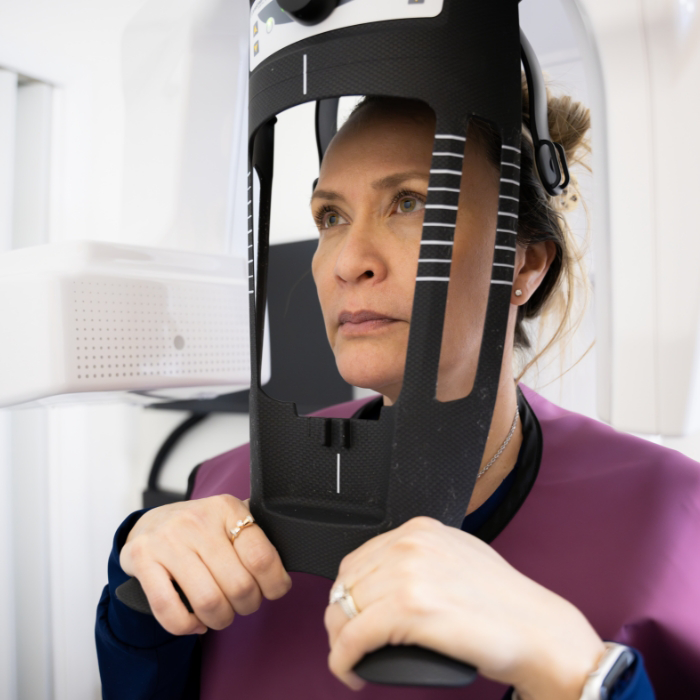 Woman about to have dental X-ray taken
