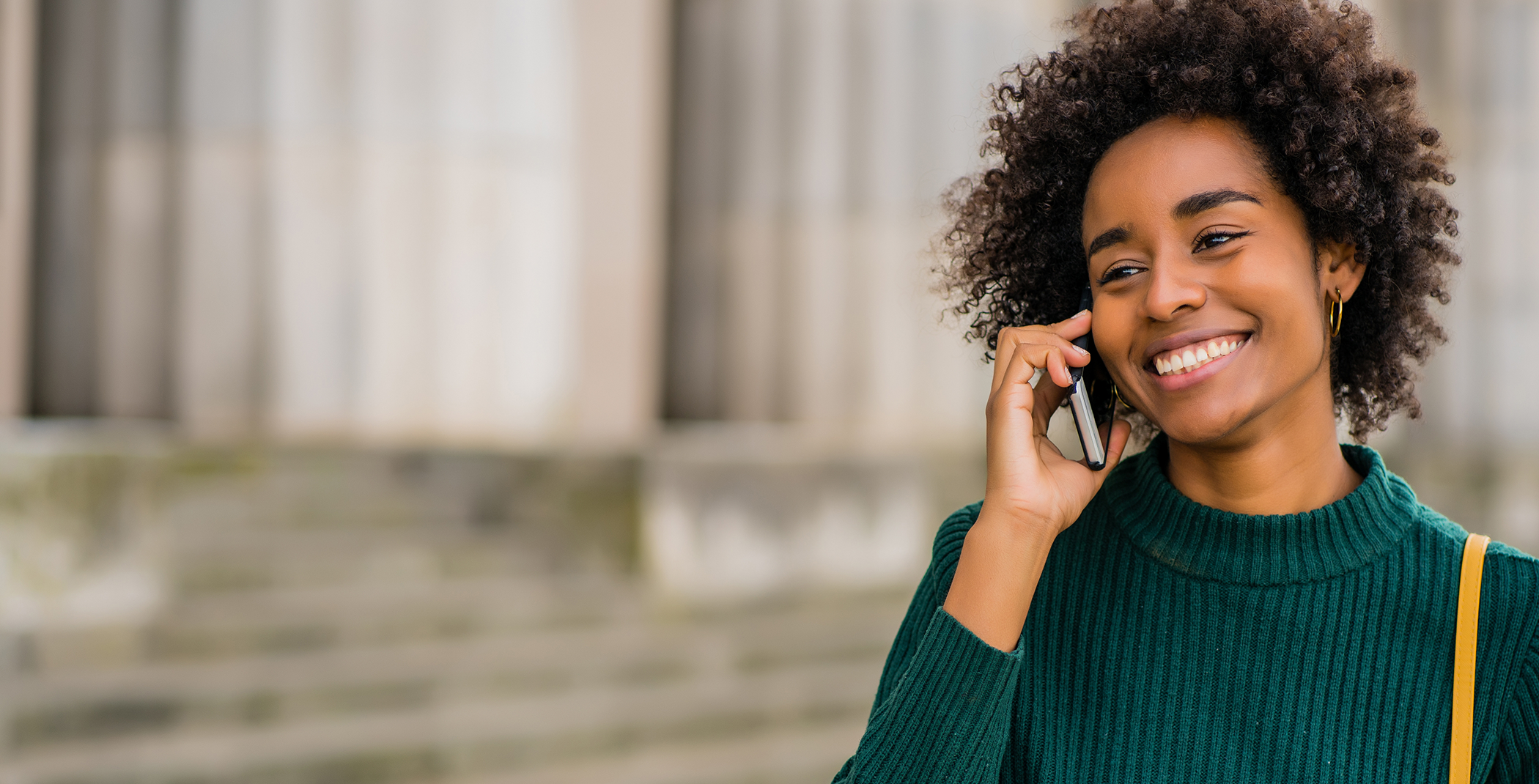 Woman in sweater talking on phone