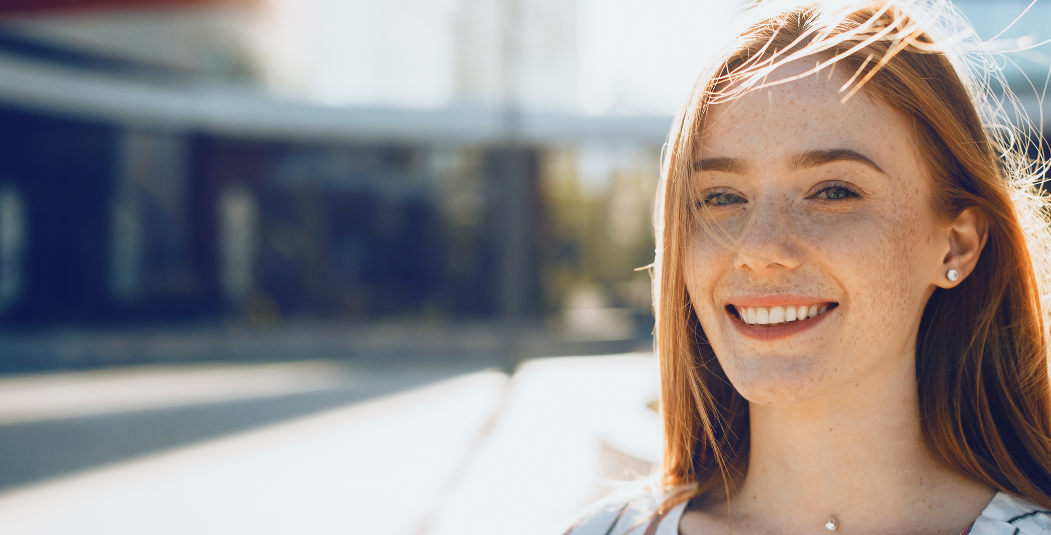 Close-up of red-haired woman with freckles smiling