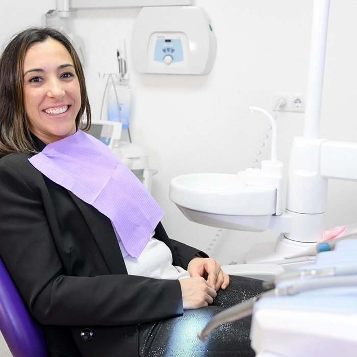 Woman sitting in dental chair smiling