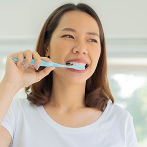 Woman at home brushing her teeth