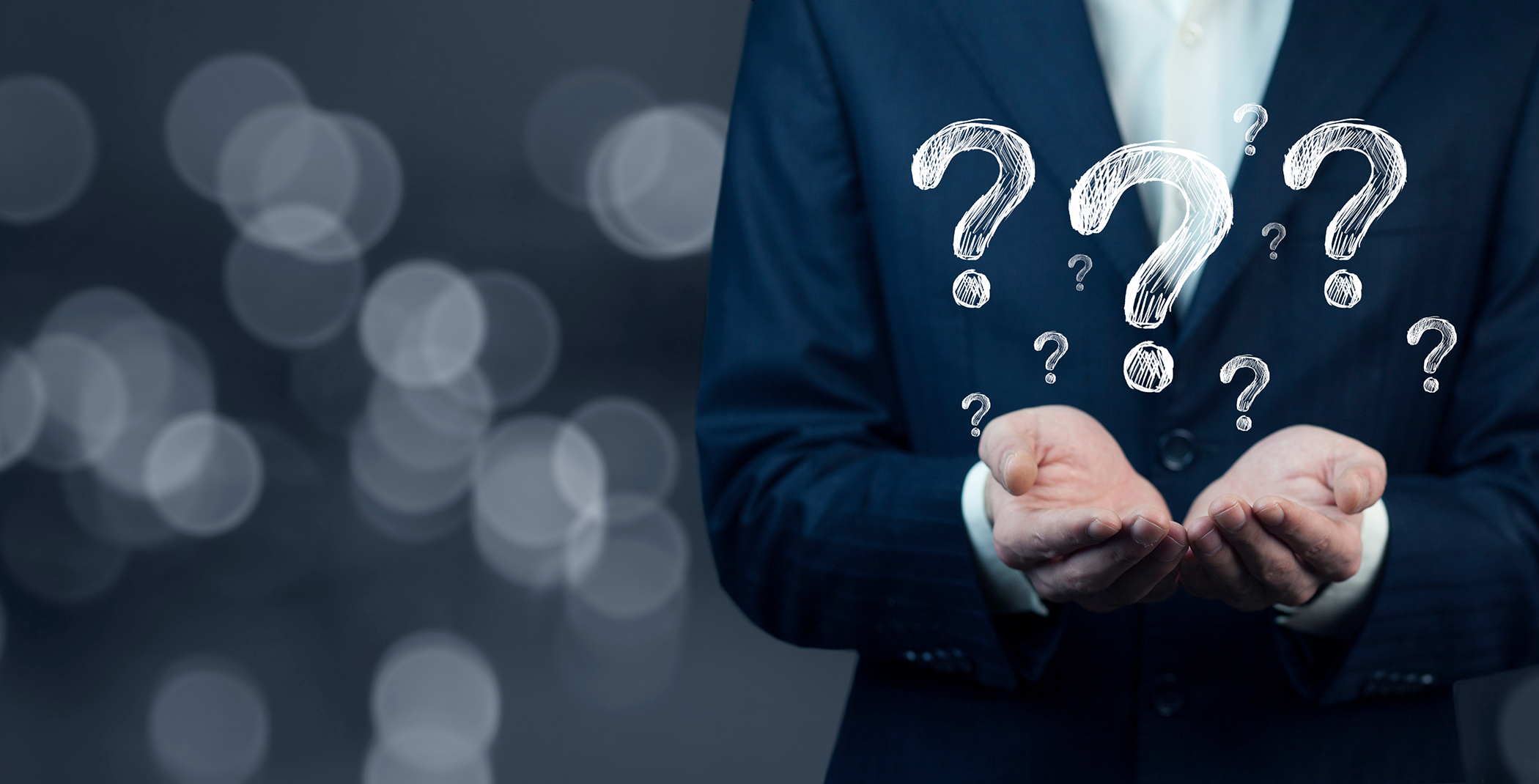 Close-up of hands surrounded by question marks