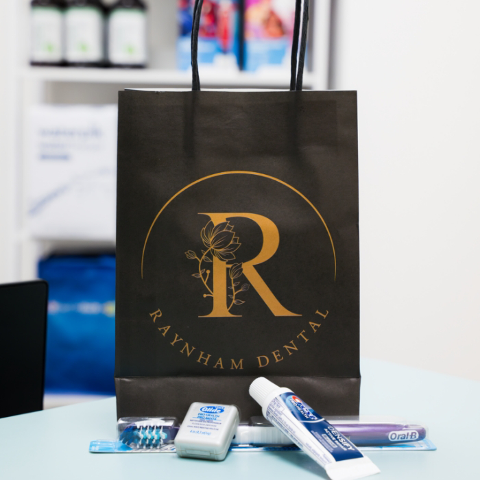 Bag with Raynham dental logo with oral hygiene products
