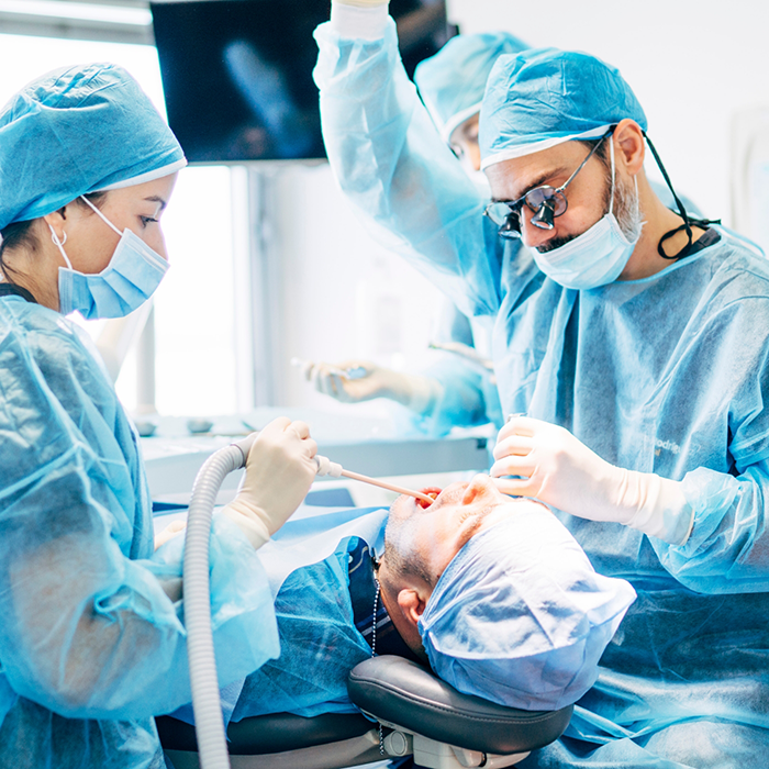 Dentists with masks treating a patient