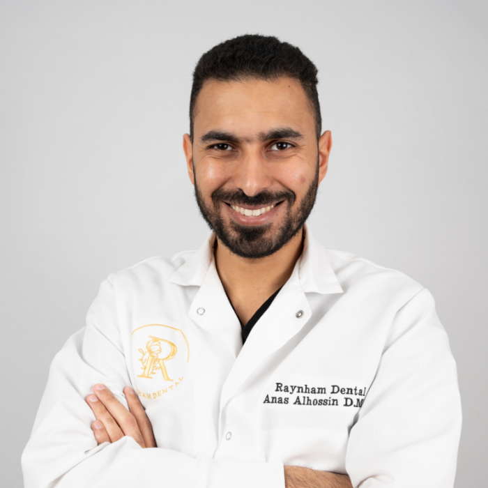 Raynham dentist Dr. Al smiling with arms folded