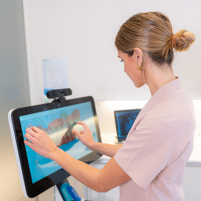Female dentist looking at computer monitor