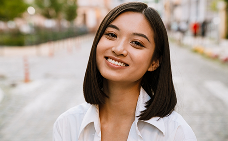 Woman walking down street and smiling