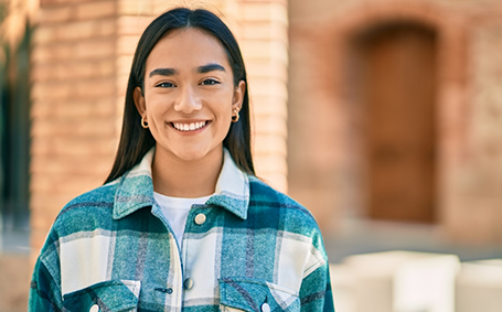 Woman in patterned shirt smiling