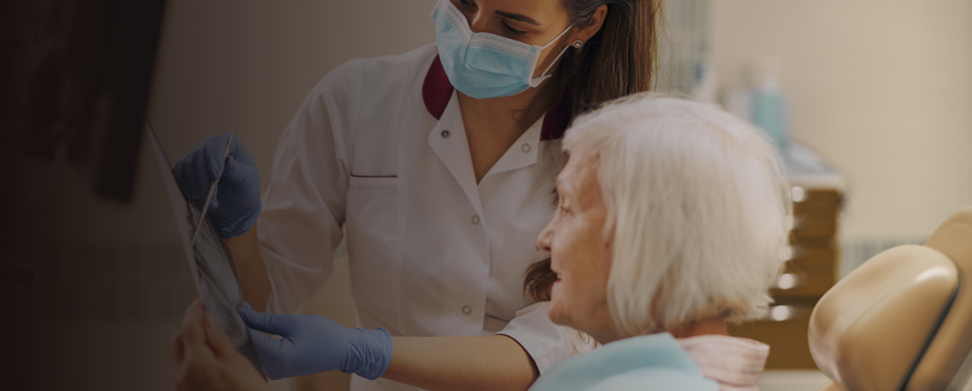 Senior female patient looking at dentist