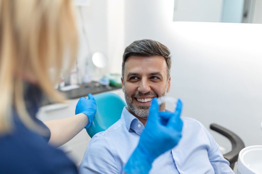 A man getting Invisalign from a dentist